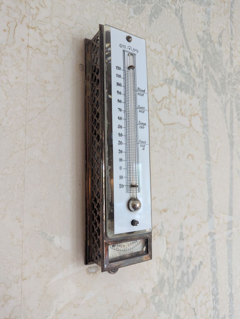 Classic vintage wall barometer with integrated thermometer, Duluth decor.